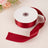 Red satin ribbon on a spool with a flowing tail.