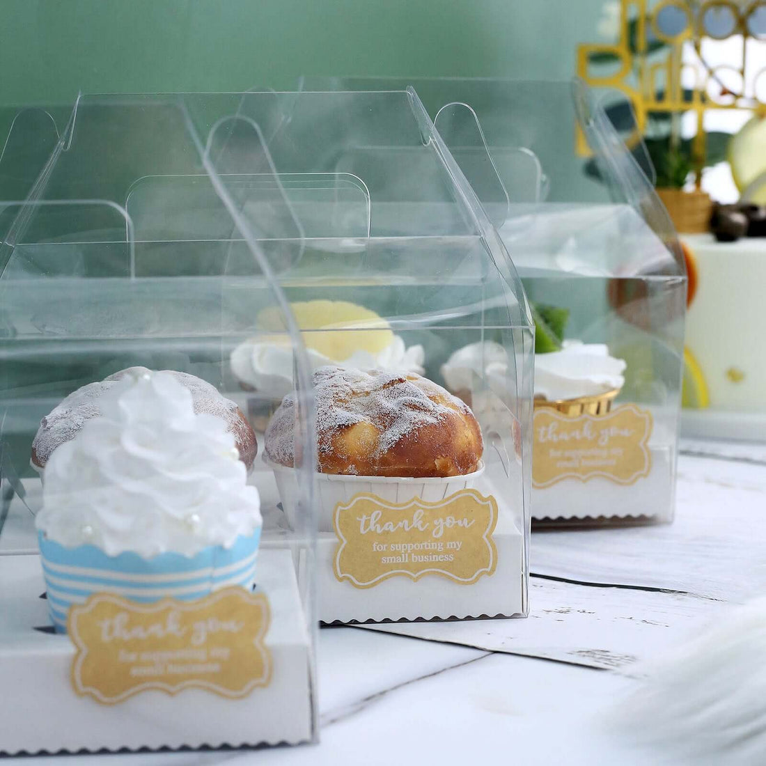 Cupcakes in clear boxes with "Thank You" labels for small business support.