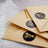 Thank you cards in elegant envelopes with black and gold stickers.