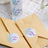 Thank you stickers on envelopes in a soft, natural setting.
