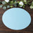 Blue circular backdrop on a wooden surface with greenery and white flowers.