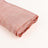 Rolled pink silk fabric showcasing smooth texture and subtle sheen