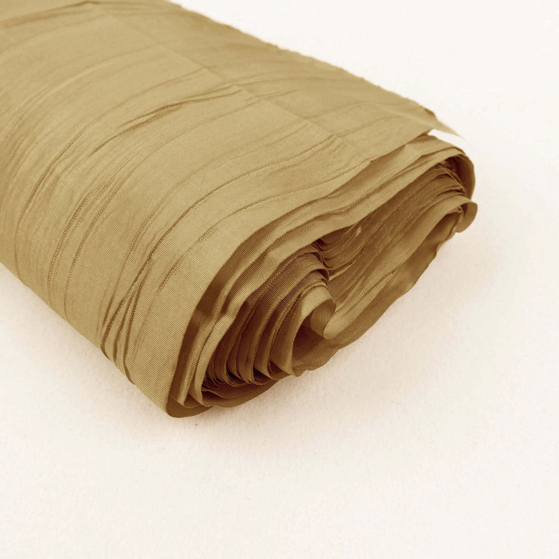 Rolled tan fabric with a textured finish on a plain backdrop