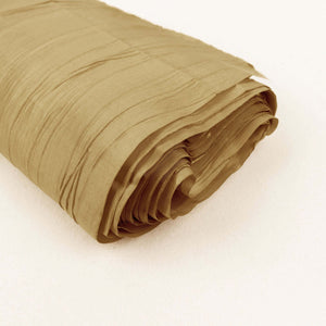 Rolled tan fabric with a textured finish on a plain backdrop