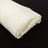 Rolled white fabric on a black background.