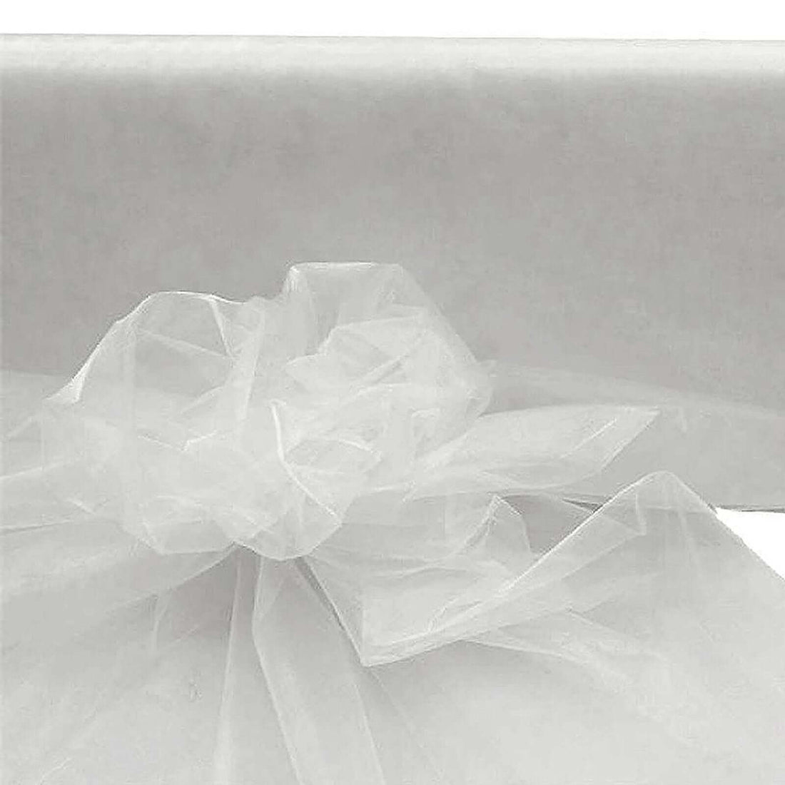 White sheer organza fabric with a bow, ideal for decorations.