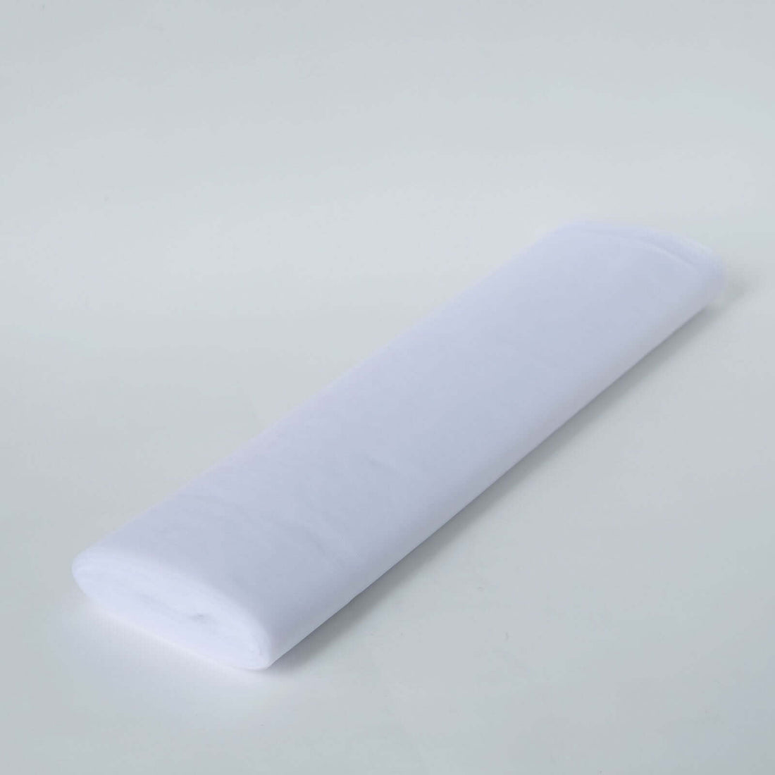 White fabric roll on a plain surface for crafting or sewing projects #whtbkgd