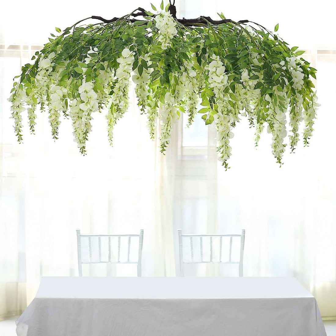 Hanging floral decoration with cascading white flowers and green leaves