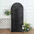 Black sequin backdrop with floral arrangement on a studio-style setup.