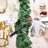 Table setting with greenery, glassware, and candles for an elegant dining experience.