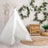 Kid's white play tent with decorative elements in a cozy room setting.