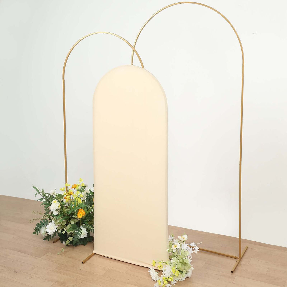 Neutral arch backdrop with floral arrangements for events or photography.