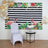 Flamingo-themed backdrop with tropical plants and balloons, featuring a chair and table.
