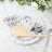 Decorative floral fan displayed on a white plate with elegant table setting.