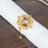 Elegant gold ring with a large faceted stone on a napkin.