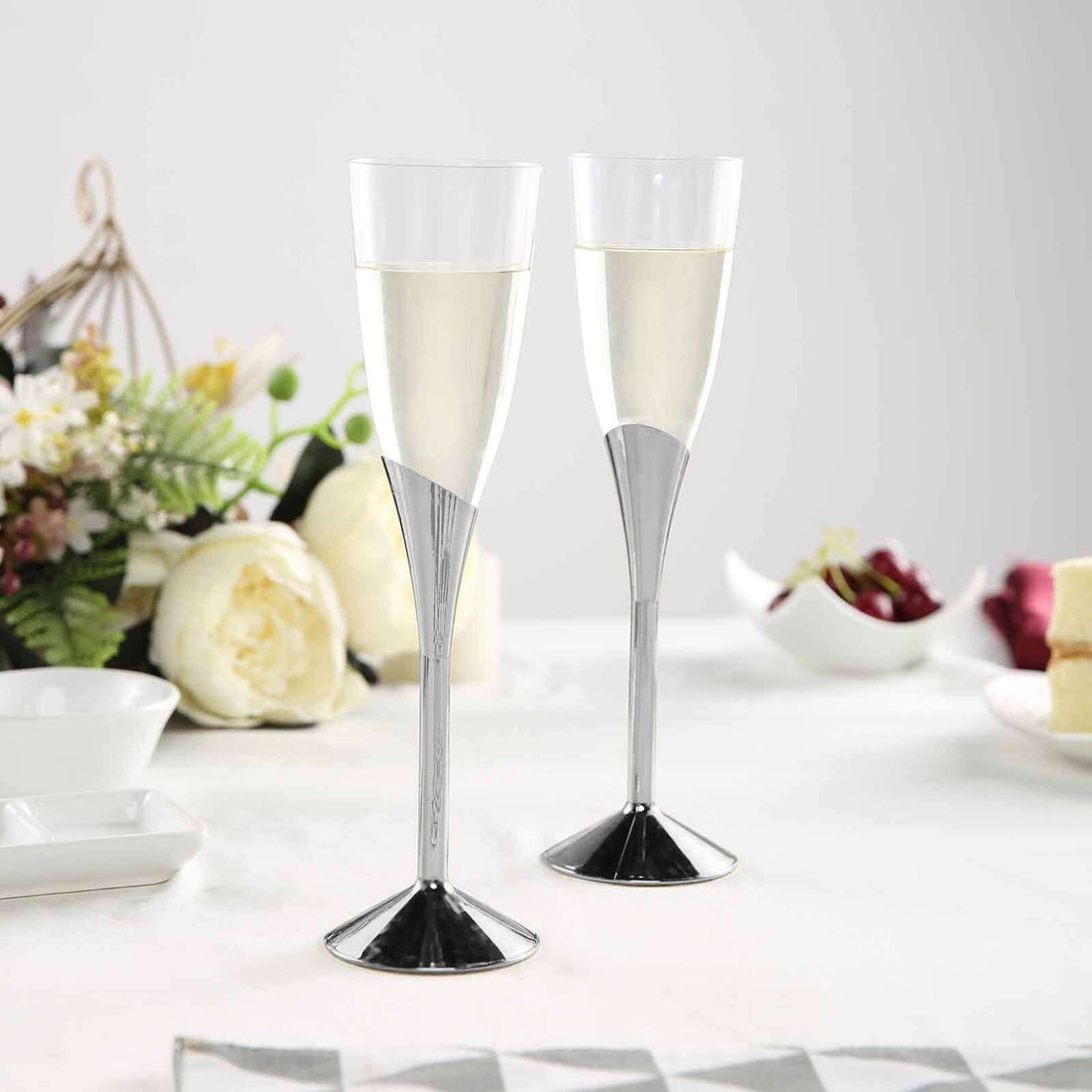 Elegant champagne flutes with sleek metallic bases and clear bowls.