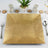 Gold square serving platter on a table setting with decorative elements.