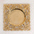 Gold decorative plate with intricate floral design and a smooth center.