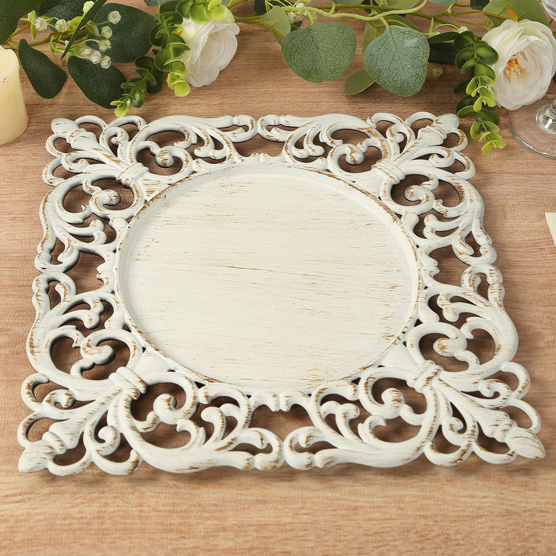 Decorative white wooden frame with intricate scrollwork design.