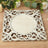 Decorative white wooden frame with intricate scrollwork design.