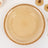 Beaded edge decorative plate in a warm beige hue.