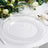 Clear decorative charger plate with beaded edge on a dining table setting.