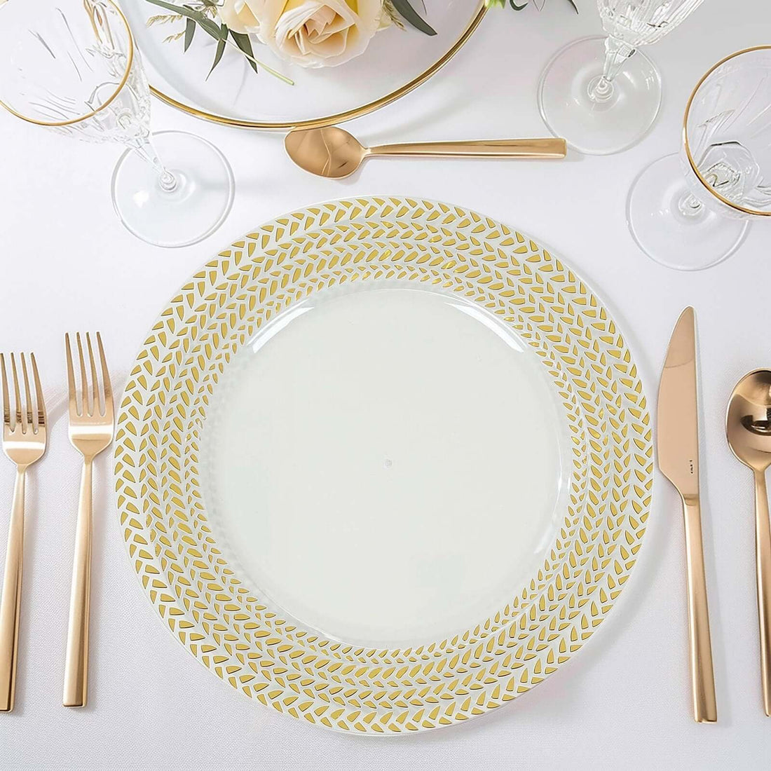 Elegant gold-patterned dinner plate on a stylish table setting.