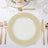 Elegant gold-patterned dinner plate on a stylish table setting.