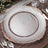 Elegant clear glass charger plate with rose gold ornate rim design.