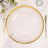 Clear charger plate with gold beaded rim on a marble tabletop.