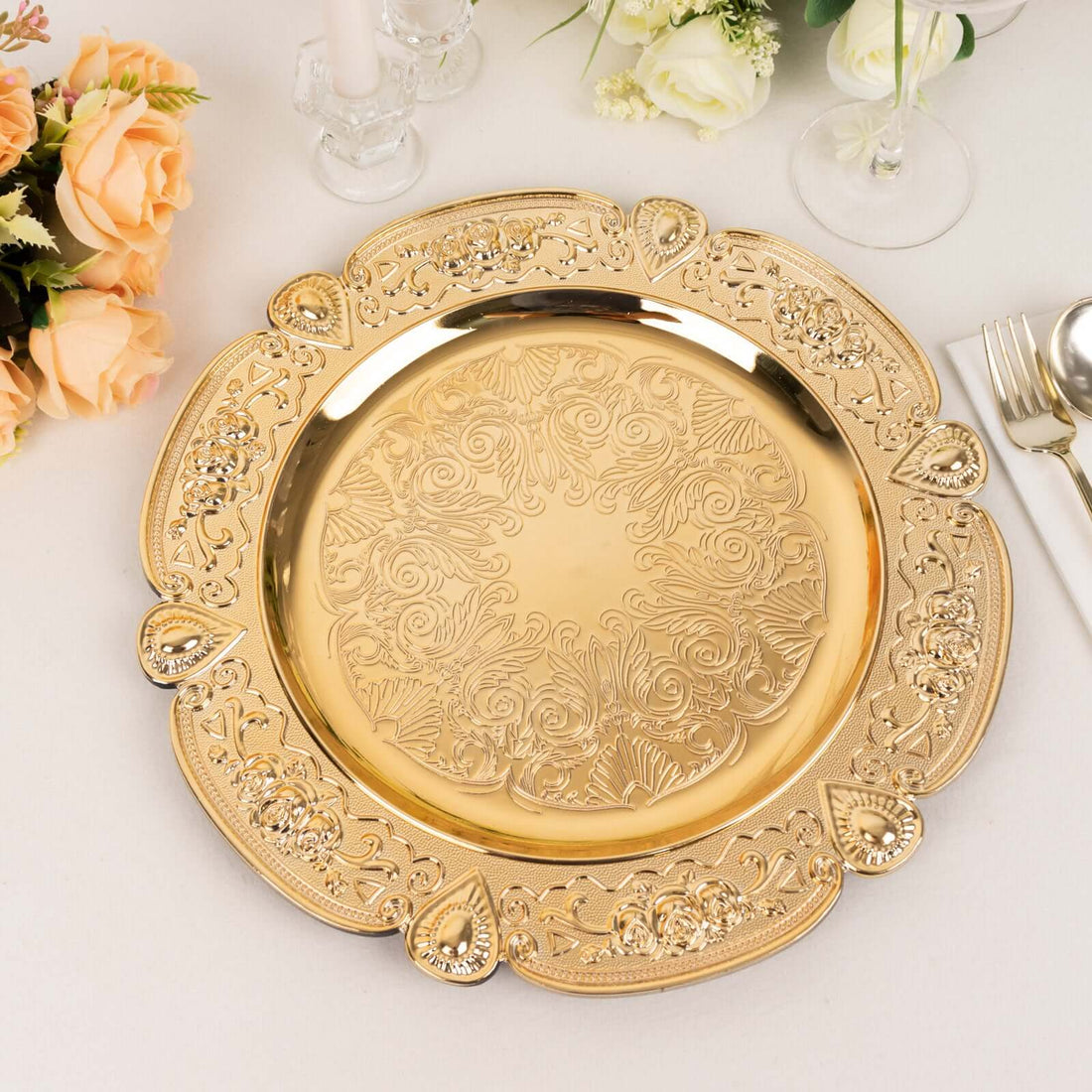 Elegant gold charger plate with intricate floral design and ornate details.
