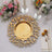 Gold decorative plate with intricate design and floral table setting.