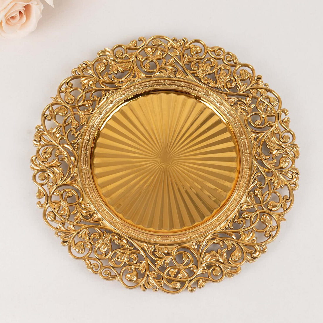 Gold ornate decorative plate with intricate design and fluted center.