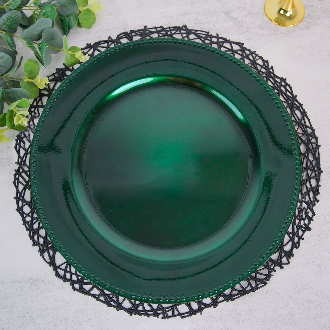 Green decorative plate on a black lace charger.