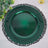 Green decorative plate on a black lace charger.