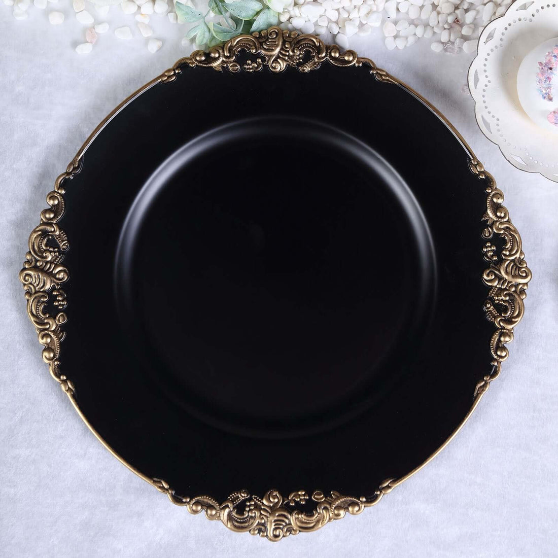 Elegant black plate with ornate gold rim design.