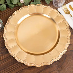 Gold charger plate with scalloped edge on a wooden table.