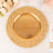 Gold decorative charger plate with textured rim for elegant dining.