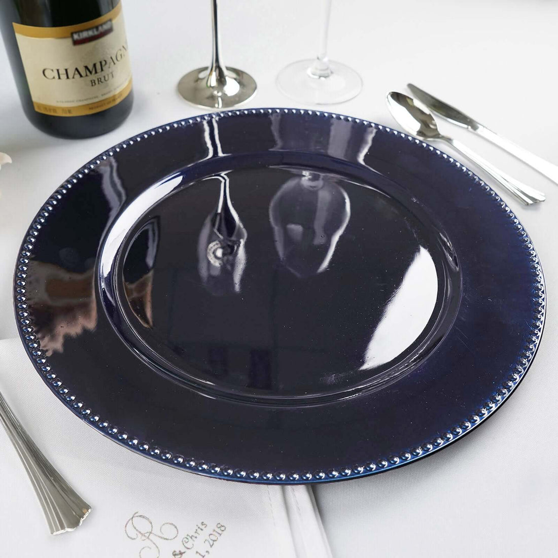 Navy blue serving plate with beaded rim on white table setting