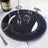 Navy blue serving plate with beaded rim on white table setting