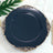 Elegant black plate with ornate gold trim on a white background.
