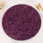 Purple round plate with gold abstract design on a marble surface.