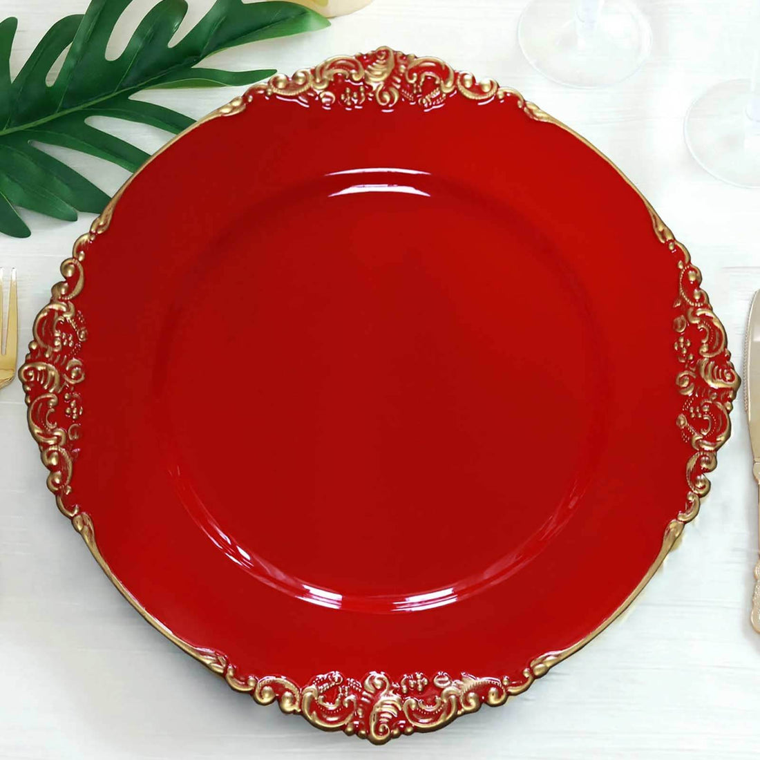 Red decorative plate with gold accents on a white background.