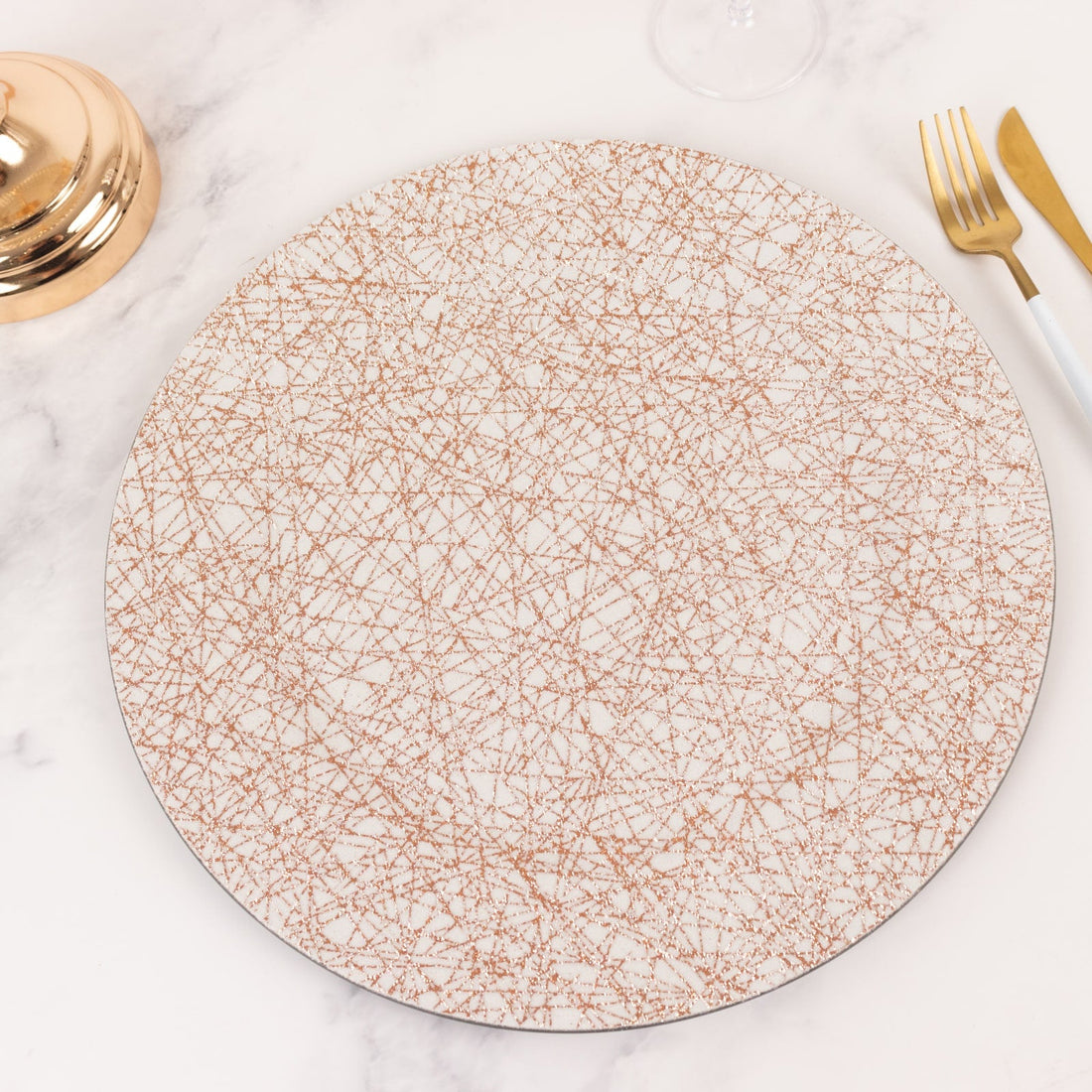 Decorative round plate with a gold geometric pattern on a white background.