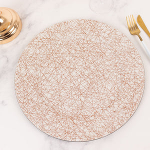 Decorative round plate with a gold geometric pattern on a white background.