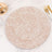 Decorative round plate with a gold geometric pattern on a white background.