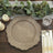 Wooden textured dinner plate with decorative edges on a rustic table setting.