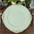 Elegant mint green plate with ornate gold trim on a wooden table setting.