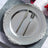 Elegant silver decorative plate with knife and fork arranged beautifully.