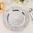 Elegant silver charger plate with floral design and embellishments, styled with table decor.